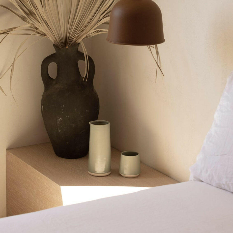 Elegant ceramic cups arranged neatly on a polished wooden table, perfect for morning coffee or tea rituals.