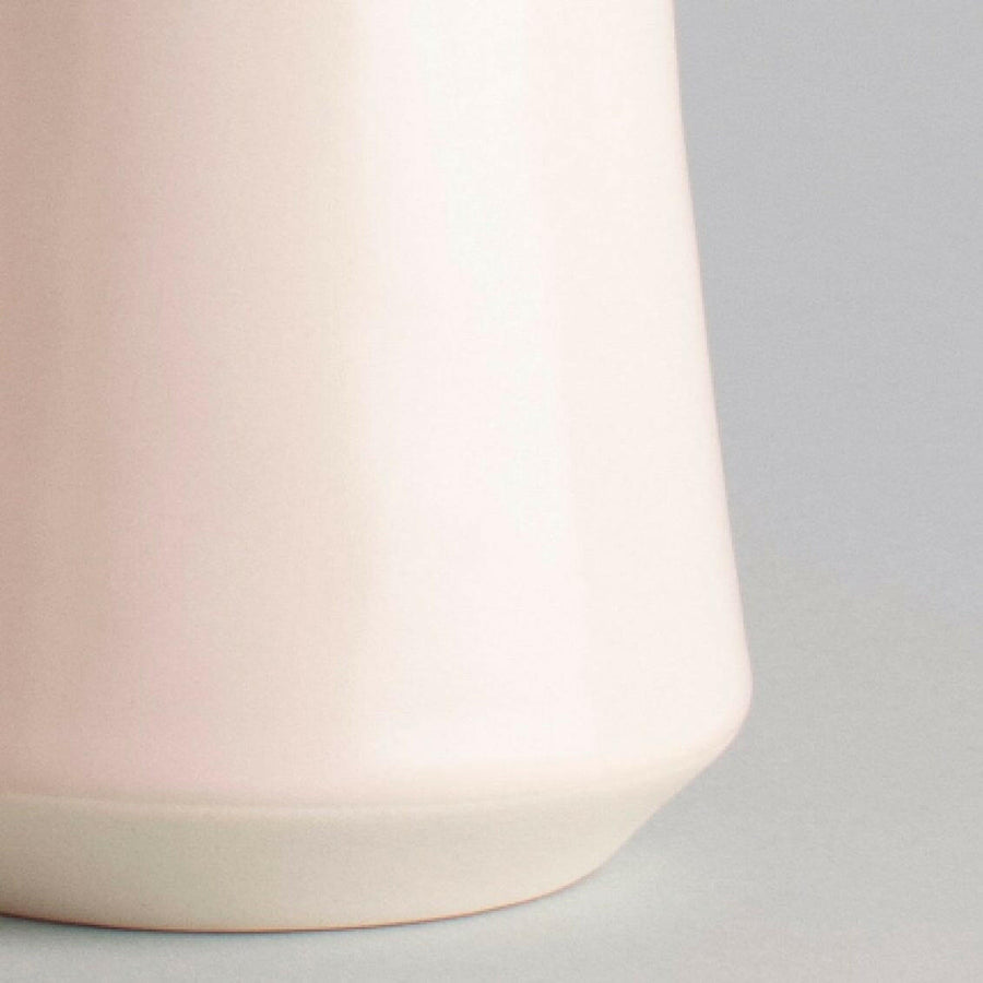 Elegant ceramic cups arranged neatly on a polished wooden table, perfect for morning coffee or tea rituals.