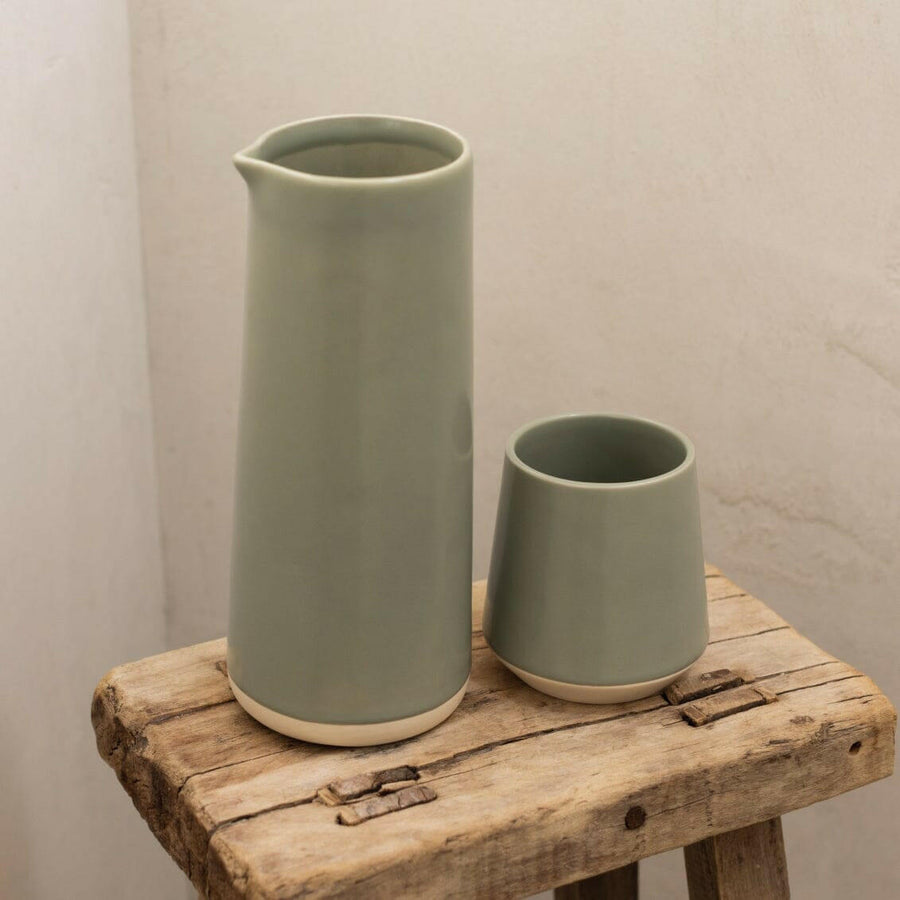Elegant ceramic cups arranged neatly on a polished wooden table, perfect for morning coffee or tea rituals.