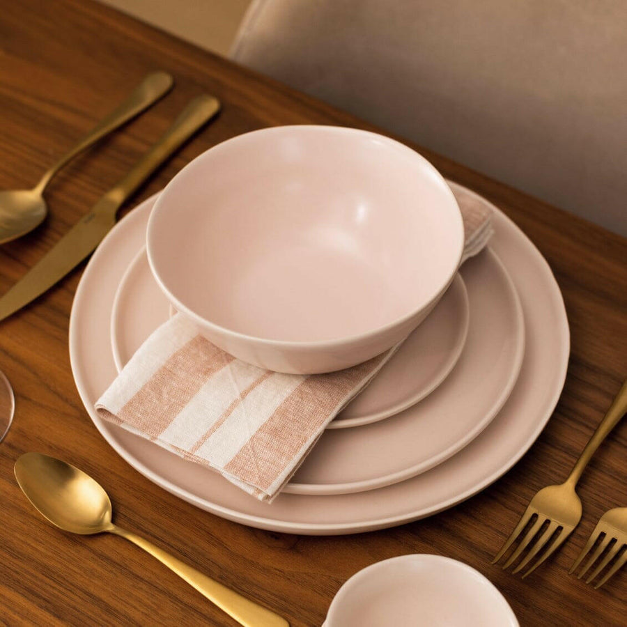 Elegant white porcelain dinnerware set featuring plates and bowls, perfect for formal dining occasions