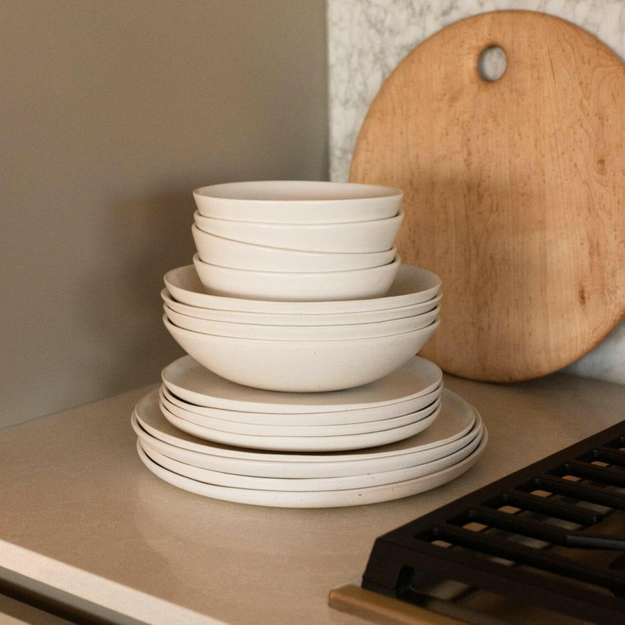 Elegant white porcelain dinnerware set featuring plates and bowls, perfect for formal dining occasions