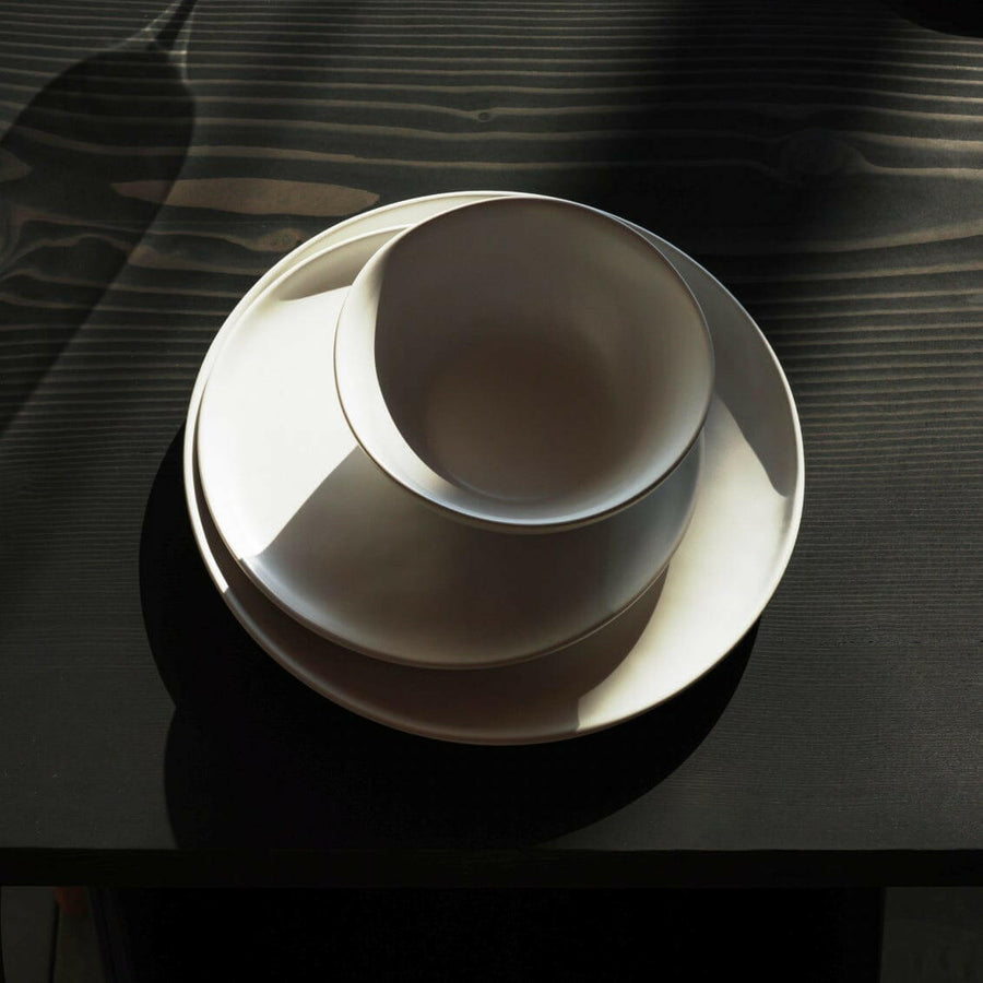 Elegant white porcelain dinnerware set featuring plates and bowls, perfect for formal dining occasions