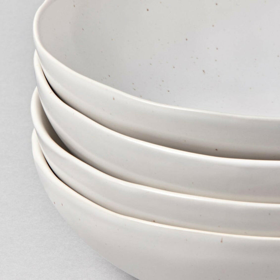 Elegant white porcelain dinnerware set featuring plates and bowls, perfect for formal dining occasions