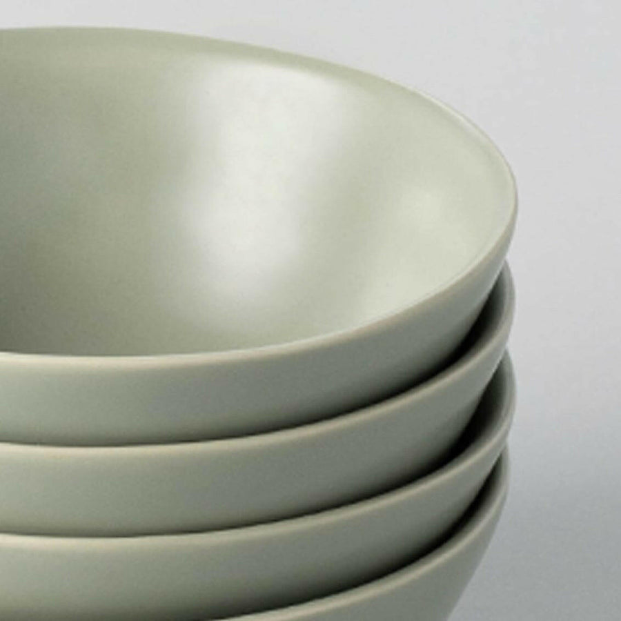 Elegant white porcelain dinnerware set featuring plates and bowls, perfect for formal dining occasions