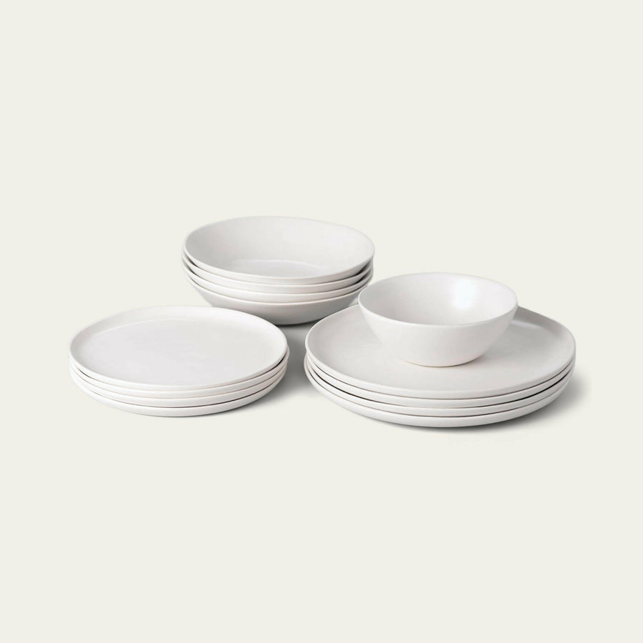 Elegant white porcelain dinnerware set featuring plates and bowls, perfect for formal dining occasions