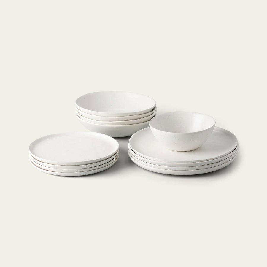 Elegant white porcelain dinnerware set featuring plates and bowls, perfect for formal dining occasions