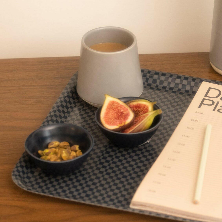 Elegant little bowls displayed on a wooden table, perfect for serving appetizers or desserts in style.