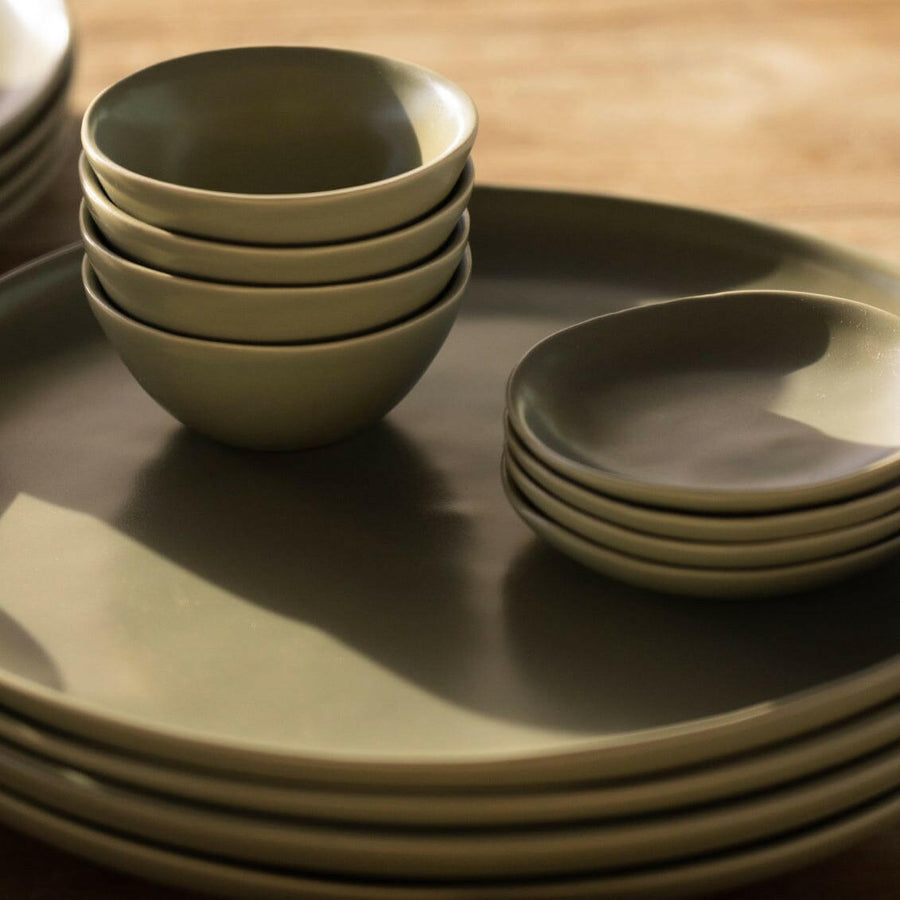Elegant little bowls displayed on a wooden table, perfect for serving appetizers or desserts in style.