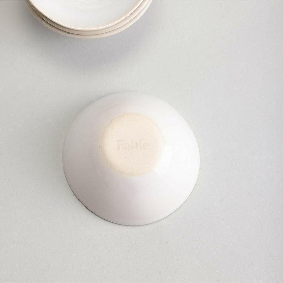 Elegant little bowls displayed on a wooden table, perfect for serving appetizers or desserts in style.