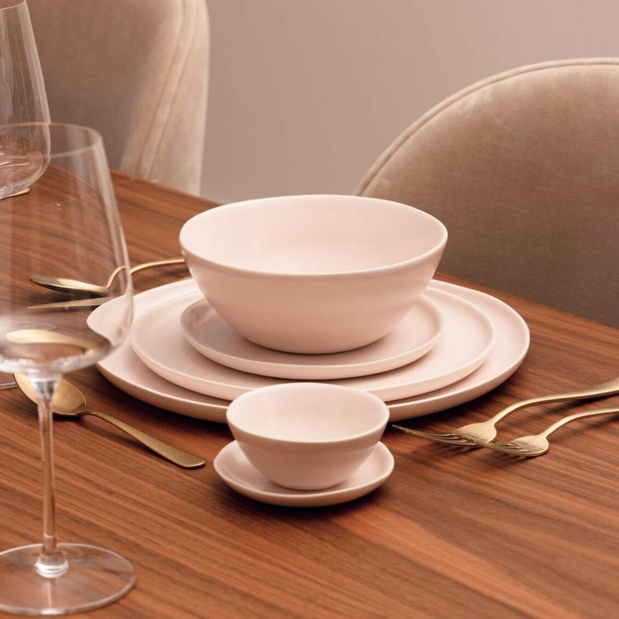 Elegant little bowls displayed on a wooden table, perfect for serving appetizers or desserts in style.