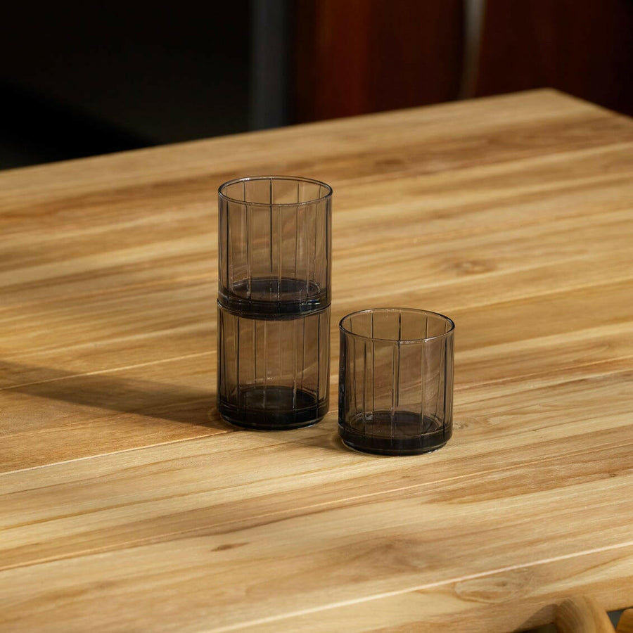 Stylish glasses resting on a bed of natural rocks, highlighting rugged elegance and clarity