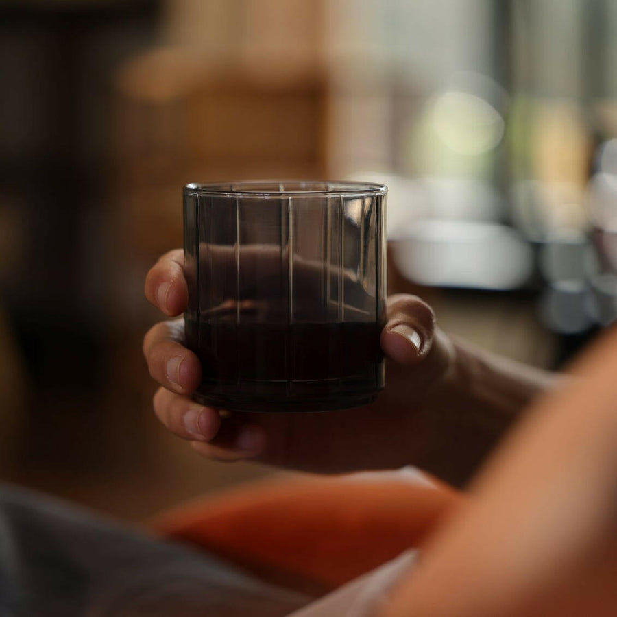 Stylish glasses resting on a bed of natural rocks, highlighting rugged elegance and clarity