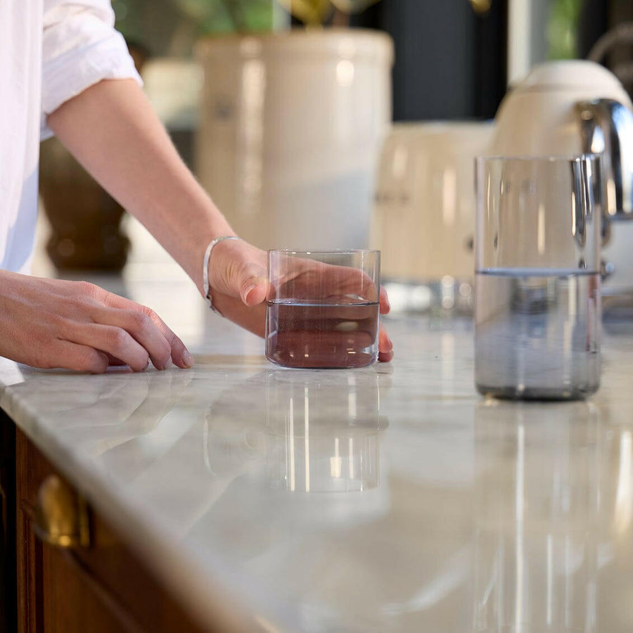 Elegant short hairstyle complemented by stylish glasses, showcasing a sophisticated and modern look for professional settings.