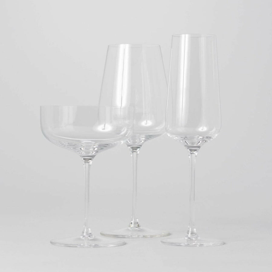 Elegant stemware set displayed on a polished wooden table, perfect for formal dining occasions and gatherings.