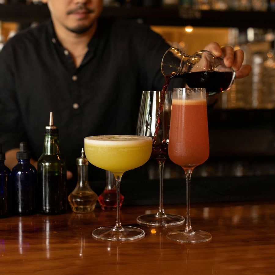 Elegant stemware set displayed on a polished wooden table, perfect for formal dining occasions and gatherings.