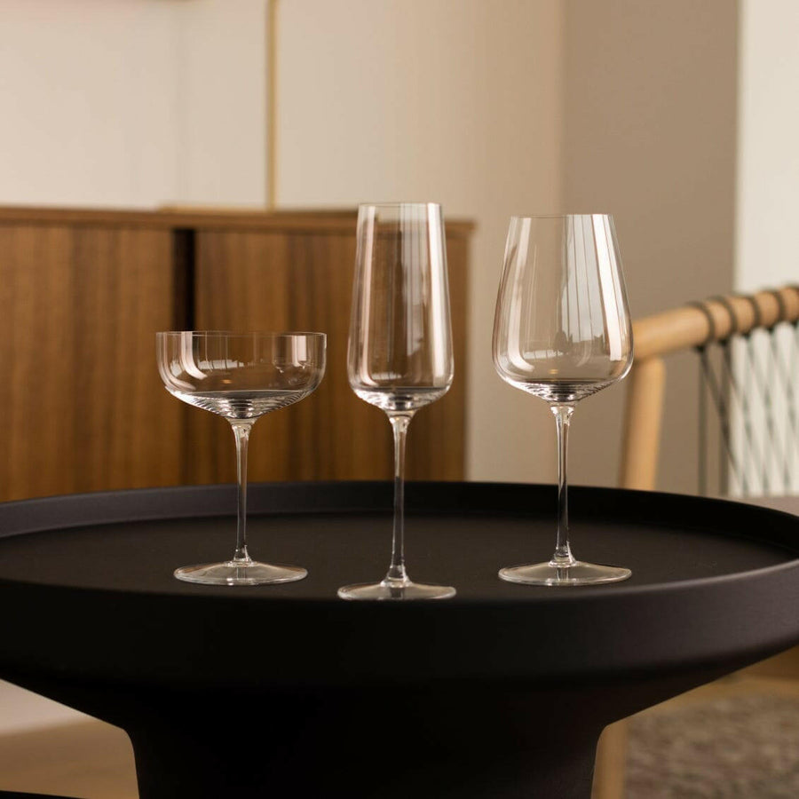 Elegant stemware set displayed on a polished wooden table, perfect for formal dining occasions and gatherings.